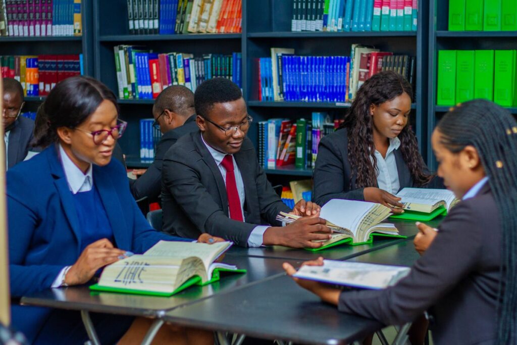 Group of students studying together around a table in a university library