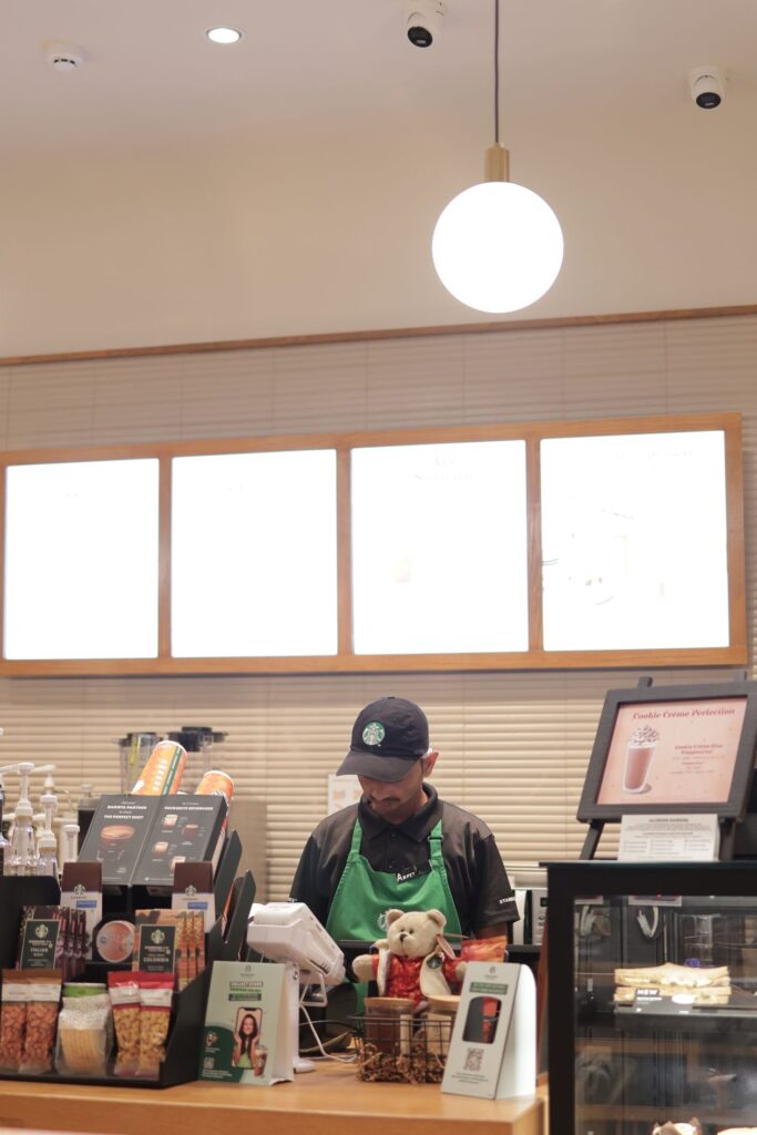 International student working a part-time barista job within UK student visa work rules