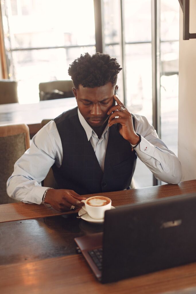 Founder working on a laptop and phone, preparing a business funding application