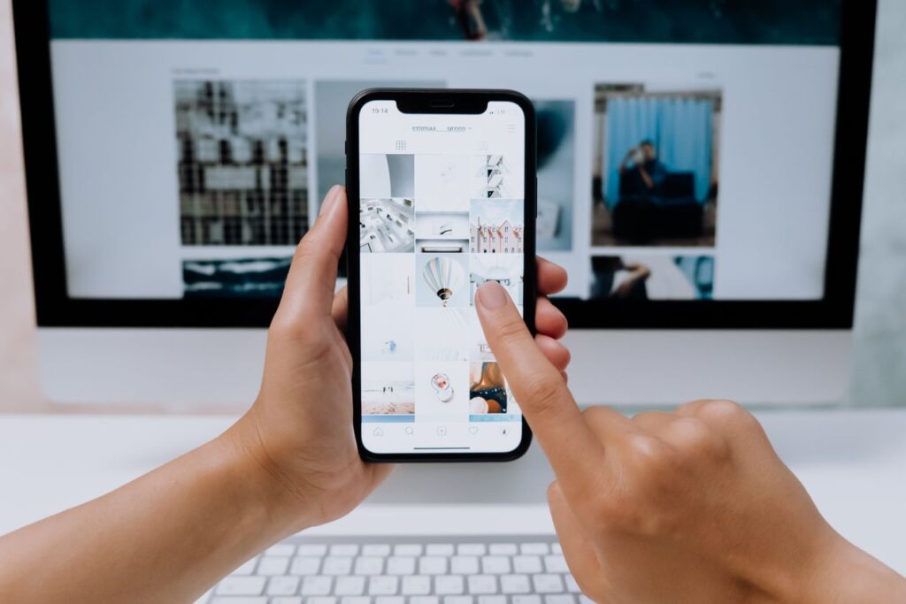 Remote social media manager working with phone and laptop — how to become a social media manager from home