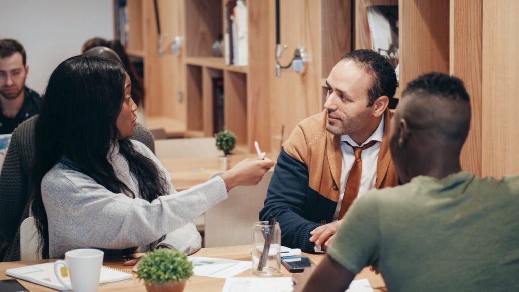 Diverse team of skilled workers collaborating in a modern office — Australia work visa sponsorship jobs 2026